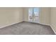 Bedroom with neutral carpet and french doors to a balcony at 2257 Norway Pine Ct, Las Vegas, NV 89134