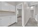 Hallway with carpet, overhead cabinets, and view of bedrooms at 2257 Norway Pine Ct, Las Vegas, NV 89134
