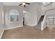Spacious living room with high ceilings, tile floors, staircase, and lots of natural light at 2257 Norway Pine Ct, Las Vegas, NV 89134