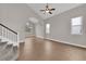 Bright living room with high ceilings, tile floors, large window, and staircase at 2257 Norway Pine Ct, Las Vegas, NV 89134