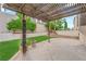The covered patio has a view of the backyard with grass and various trees at 2257 Norway Pine Ct, Las Vegas, NV 89134