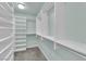 Well-organized walk-in closet with built-in shelves and hanging rods at 2257 Norway Pine Ct, Las Vegas, NV 89134