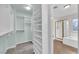 Open walk-in closet with built-in shelves, and adjacent bathroom at 2257 Norway Pine Ct, Las Vegas, NV 89134