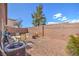 Spacious backyard with gravel, a patio set, brick privacy wall and landscaping at 2920 Riarosa Ct, North Las Vegas, NV 89086