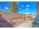 Backyard with a patio, gravel area, and high brick wall providing privacy at 2920 Riarosa Ct, North Las Vegas, NV 89086