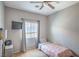 This bedroom features a ceiling fan, window with blinds, mounted television and neutral wall color at 2920 Riarosa Ct, North Las Vegas, NV 89086