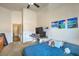 Cozy bedroom with vaulted ceiling, a desk setup, a blue comforter and natural light coming from large window at 2920 Riarosa Ct, North Las Vegas, NV 89086