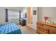 A tidy bedroom with a bed, natural light, and view leading to a bathroom at 2920 Riarosa Ct, North Las Vegas, NV 89086