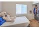 Bright bedroom with a plush mattress and a large teddy bear, complemented by a walk-in closet at 2920 Riarosa Ct, North Las Vegas, NV 89086
