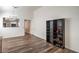 Open-concept living room featuring wood-look flooring and a built-in shelving unit at 2920 Riarosa Ct, North Las Vegas, NV 89086