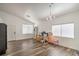 Bright and open room featuring wood-look flooring, a chandelier, and plenty of natural light at 2920 Riarosa Ct, North Las Vegas, NV 89086