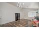 Bright living room with wood-look floors, a chandelier, and ample natural light at 2920 Riarosa Ct, North Las Vegas, NV 89086
