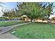 Expansive backyard showcasing mature trees, vibrant greenery, and a swing set at 2926 E Eldorado Ln, Las Vegas, NV 89120