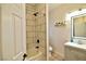 Modern bathroom with tiled shower-tub combination and vanity with attractive lighting at 2926 E Eldorado Ln, Las Vegas, NV 89120