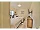 Bright bedroom featuring two twin beds, stylish furnishings, and a mounted TV at 2926 E Eldorado Ln, Las Vegas, NV 89120