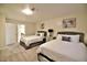 Bright bedroom with two beds, carpeted floors, and ensuite bathroom access at 2926 E Eldorado Ln, Las Vegas, NV 89120