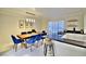 Bright dining area with stylish lighting, dining table with blue chairs and white countertops at 2926 E Eldorado Ln, Las Vegas, NV 89120