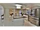Modern open-concept kitchen with a large kitchen island and stainless steel refrigerator at 2926 E Eldorado Ln, Las Vegas, NV 89120