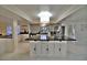 Open-concept kitchen with a large island, white cabinetry, and stainless steel appliances at 2926 E Eldorado Ln, Las Vegas, NV 89120