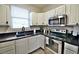 Well-equipped kitchen with stainless steel appliances, granite countertops, and ample cabinet space at 2926 E Eldorado Ln, Las Vegas, NV 89120
