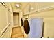 Convenient laundry room with washer, dryer, and built-in cabinets for storage at 2926 E Eldorado Ln, Las Vegas, NV 89120