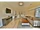 Cozy living room featuring a sectional sofa, modern TV, and stylish decor at 2926 E Eldorado Ln, Las Vegas, NV 89120