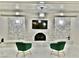 Stylish living room with a stone fireplace, modern lighting, and comfortable green chairs at 2926 E Eldorado Ln, Las Vegas, NV 89120