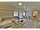 Spacious living room with a sectional sofa, dining area, and plenty of natural light at 2926 E Eldorado Ln, Las Vegas, NV 89120