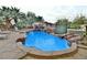 Outdoor pool area with rock waterfall feature and lush landscaping at 2926 E Eldorado Ln, Las Vegas, NV 89120