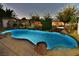 Nighttime view of illuminated swimming pool with rock features at 2926 E Eldorado Ln, Las Vegas, NV 89120