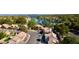 Aerial view of a residential neighborhood with lush green trees and a serene lake in the background at 3005 Treasure Island Rd, Las Vegas, NV 89128