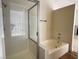 Bathroom featuring separate shower and tub with tiled walls at 3005 Treasure Island Rd, Las Vegas, NV 89128