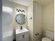Bathroom featuring a modern vanity with a round mirror and toilet at 3005 Treasure Island Rd, Las Vegas, NV 89128