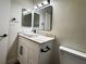 Modern bathroom features a new vanity with granite countertops and black hardware at 3005 Treasure Island Rd, Las Vegas, NV 89128