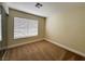 Bright bedroom features a window for natural light and a closet with mirrored doors at 3005 Treasure Island Rd, Las Vegas, NV 89128
