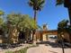 Elegant clubhouse with covered entry, lush landscaping, and architectural details for community events at 3005 Treasure Island Rd, Las Vegas, NV 89128