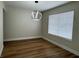 Dining room with modern light fixture and window with blinds at 3005 Treasure Island Rd, Las Vegas, NV 89128