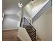 Inviting entryway features modern light fixture and stairway with sleek, black metal railings at 3005 Treasure Island Rd, Las Vegas, NV 89128
