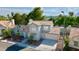 Charming two-story home with a well-maintained lawn, mature trees, and a convenient two-car garage at 3005 Treasure Island Rd, Las Vegas, NV 89128