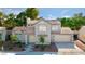 Charming two-story home with a well-maintained lawn, mature trees, and a convenient two-car garage at 3005 Treasure Island Rd, Las Vegas, NV 89128