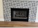 Close up of fireplace with black and white tile surround and dark hearth at 3005 Treasure Island Rd, Las Vegas, NV 89128