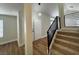 Bright foyer featuring hardwood flooring, modern staircase, and a stylish pendant light at 3005 Treasure Island Rd, Las Vegas, NV 89128
