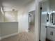 Well-lit hallway features a modern chandelier, leading to another room and a bathroom at 3005 Treasure Island Rd, Las Vegas, NV 89128