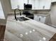 Bright kitchen featuring white cabinets, granite countertops, and stainless steel appliances at 3005 Treasure Island Rd, Las Vegas, NV 89128