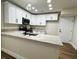 Well-appointed kitchen features white cabinets, modern fixtures, and granite countertops at 3005 Treasure Island Rd, Las Vegas, NV 89128