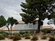 A view of well-maintained backyard landscaping featuring gravel, greenery and a red-tiled roof home at 3005 Treasure Island Rd, Las Vegas, NV 89128
