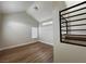Bright living room features wood-look floors, a vaulted ceiling, and ample natural light at 3005 Treasure Island Rd, Las Vegas, NV 89128