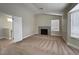 Spacious loft area featuring a cozy fireplace with decorative tile and natural light from large windows at 3005 Treasure Island Rd, Las Vegas, NV 89128