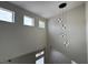 Modern staircase with pendant lighting and several windows at 3005 Treasure Island Rd, Las Vegas, NV 89128