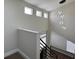 Staircase featuring modern railing, overhead windows, and contemporary light fixture at 3005 Treasure Island Rd, Las Vegas, NV 89128